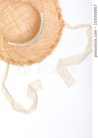 Pretty beautiful straw hat with ribbon and bow on white background beach hat from a side view isolated. Pretty beautiful straw hat with ribbon and bow on white background beach hat from a side view isolated. 105000067