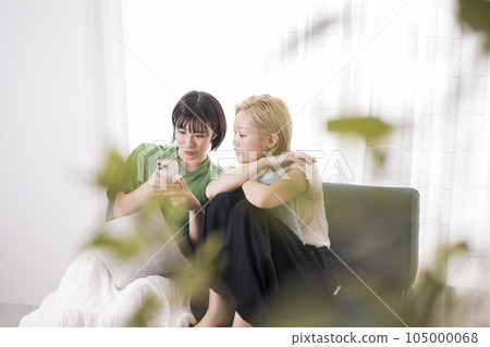 Young woman looking at a smartphone Young woman looking at a smartphone 105000068