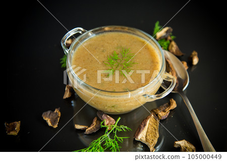 hot homemade vegetable vegetarian soup with dried mushrooms in a glass bowl hot homemade vegetable vegetarian soup with dried mushrooms in a glass bowl 105000449