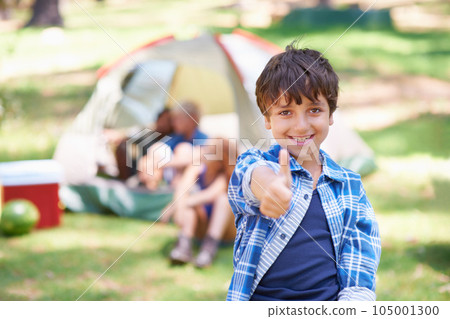 Happy kid, portrait smile and thumbs up for camping success, winning or victory in nature. Little boy or child smiling and showing thumb emoji, yes sign or like for camp setup, victory or approval Happy kid, portrait smile and thumbs up for camping success, winning or victory in nature. Little boy or child smiling and showing thumb emoji, yes sign or like for camp setup, victory or approval 105001300