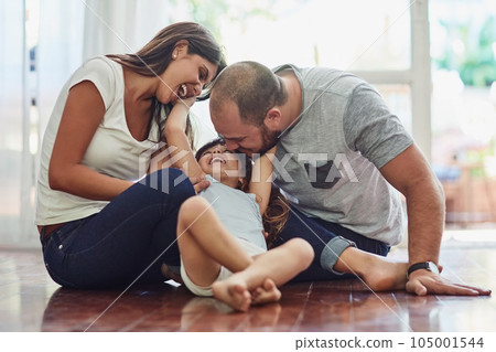 Family, parents with their daughter playing and happy in living room of their home. Love or care, support and cheerful or happy people spend quality or bonding time together on floor at their house. Family, parents with their daughter playing and happy in living room of their home. Love or care, support and cheerful or happy people spend quality or bonding time together on floor at their house. 105001544