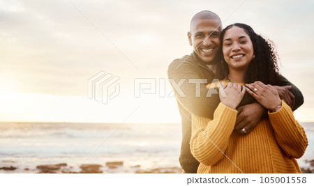 Hug, happy and portrait of a couple at the beach for a date, bonding or sunset in Bali. Love, embrace and young man and woman smiling while relaxing at the ocean for vacation with mockup space 105001558