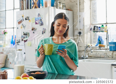 Phone, coffee or woman in house kitchen for communication or social network on media app in morning. Tea, smile or happy girl on smartphone reading social media news, networking or mobile internet 105001572
