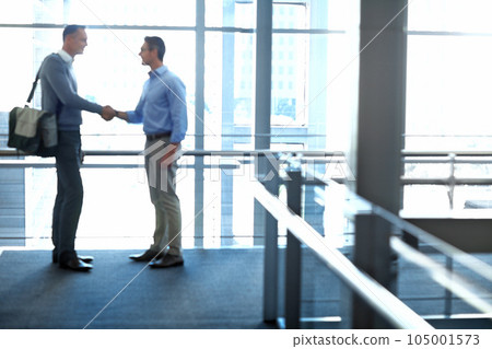 Business men, handshake and partnership deal in hotel lobby, modern office or airport lounge in CRM team meeting. Corporate people, employees and shaking hands in collaboration, agreement or success 105001573