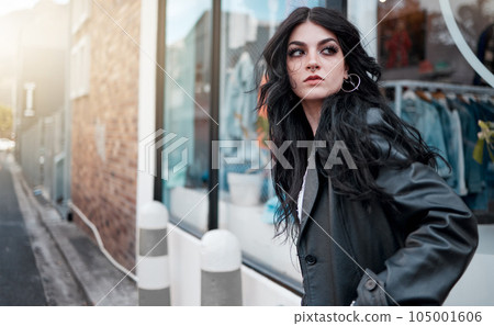 Urban fashion, style and a woman on the street at shop window, punk streetwear outside designer boutique. Beauty, make up and gen z fashion model or rock influencer in the city at store window. 105001606