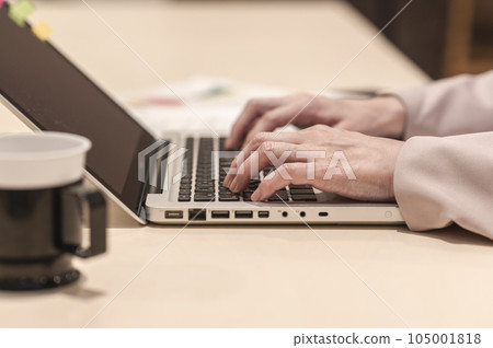 A woman working while having a drink A woman working while having a drink 105001818