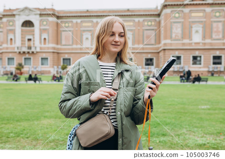 Young blonde woman listening to audio guide at the Vatican Museums in Rome, Italy 105003746