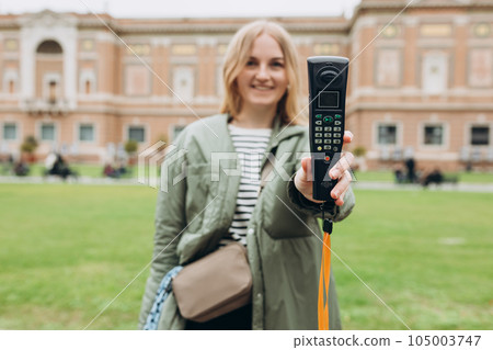 Young blonde woman listening to audio guide at the Vatican Museums in Rome, Italy Young blonde woman listening to audio guide at the Vatican Museums in Rome, Italy 105003747
