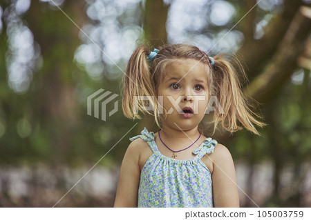 Adorable surprised child in the garden in Denmark 105003759
