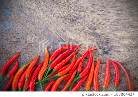 Fresh red chili on an old wooden background. 105004424