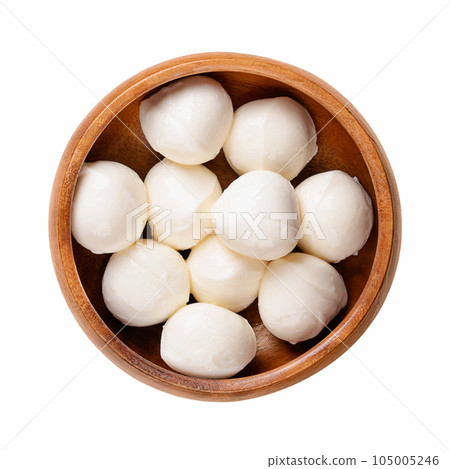 Mini mozzarella balls, in a wooden bowl. Fresh white southern Italian cheese made from milk by the pasta filata method, also called bambini bocconcini. Used for pizza, pasta dishes or Caprese salad. 105005246