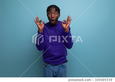emotional thinking black american young man with dreadlocks in casual clothes 105005559