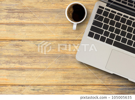 Laptop keyboard and coffee on the brown wooden desk 105005635