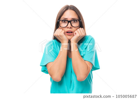 young surprised caucasian female model in glasses with black silky smooth hair dressed in a blue t 105005687