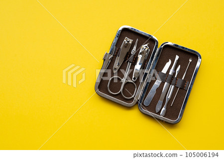 Manicure set on a yellow background close-up 105006194