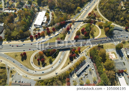 American freeway intersection with fast driving cars and trucks. View from above of USA transportation infrastructure 105006195