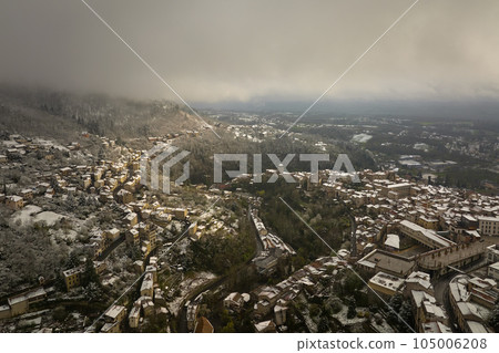 Aerial winter landscape of dense historic center of Thiers town in Puy-de-Dome department, Auvergne-Rhone-Alpes region in France. Rooftops of old buildings and narrow streets at snowfall 105006208