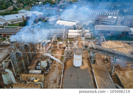 Aerial view of wood processing plant with smokestack from production process polluting environment at factory manufacturing yard 105006219