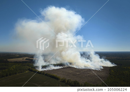 Aerial view of white smoke from forest fire rising up polluting atmosphere. Natural disaster concept Aerial view of white smoke from forest fire rising up polluting atmosphere. Natural disaster concept 105006224