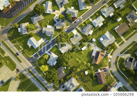 Aerial view of small town America suburban landscape with private homes between green palm trees in Florida quiet residential area Aerial view of small town America suburban landscape with private homes between green palm trees in Florida quiet residential area 105006299