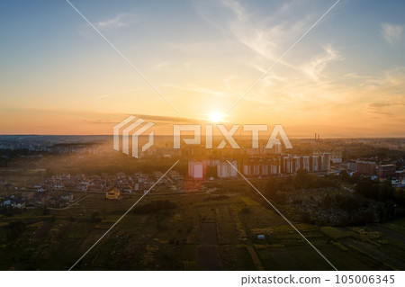 Aerial view of residential houses in suburban rural area at sunset Aerial view of residential houses in suburban rural area at sunset 105006345