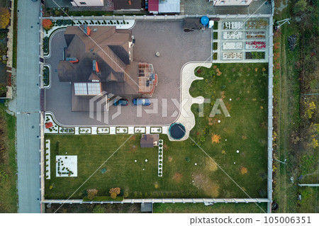 Aerial view of residential house with backyard in suburban rural area 105006351