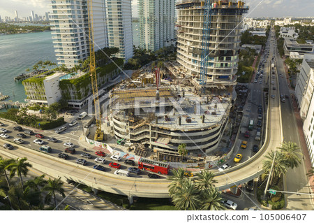 Aerial view of new developing residense in american urban area. Tower cranes at industrial construction site in Miami, Florida. Concept of housing growth in the USA Aerial view of new developing residense in american urban area. Tower cranes at industrial construction site in Miami, Florida. Concept of housing growth in the USA 105006407