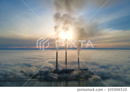 Aerial view of coal power plant high pipes with black smoke moving up polluting atmosphere at sunset Aerial view of coal power plant high pipes with black smoke moving up polluting atmosphere at sunset 105006520