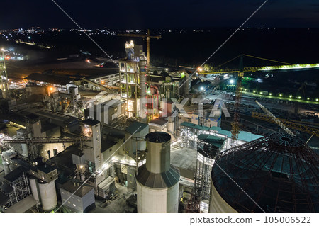 Aerial view of cement factory with high concrete plant structure and tower cranes at industrial production area at night. Manufacture and global industry concept. Aerial view of cement factory with high concrete plant structure and tower cranes at industrial production area at night. Manufacture and global industry concept. 105006522