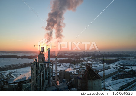 Aerial view of cement factory with high concrete plant structure and tower crane at industrial production area in evening. Manufacture and global industry concept Aerial view of cement factory with high concrete plant structure and tower crane at industrial production area in evening. Manufacture and global industry concept 105006526