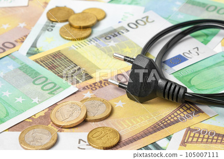Power plug on Euro Banknotes Background. Increasing Consumption. Cost of Electricity and Expensive Energy Concept. Price Hike. Heating Crisis. Utility Bill Saving, Conservation. Annually Inflation 105007111