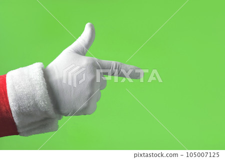 Santa Claus Hand Pointing to the Front with Index Finger Isolated On Green Background. Close Up. White Gloved Hand Points Forward at Something with one finger. Chroma Key Screen. Advertisement gesture Santa Claus Hand Pointing to the Front with Index Finger Isolated On Green Background. Close Up. White Gloved Hand Points Forward at Something with one finger. Chroma Key Screen. Advertisement gesture 105007125