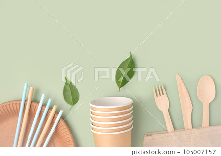 Eco - Friendly Tableware on Green Background. Top View. Plastic free Set of Brown Paper Utensil. Street Food Recyclable Packaging. Zero waste Paperware. Mockup. Disposable Take out Cup, wooden cutlery Eco - Friendly Tableware on Green Background. Top View. Plastic free Set of Brown Paper Utensil. Street Food Recyclable Packaging. Zero waste Paperware. Mockup. Disposable Take out Cup, wooden cutlery 105007157