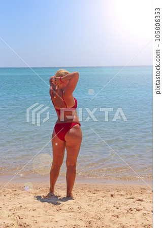 Girl sunbathing on beach during vacation. Woman enjoying relaxing at sea Girl sunbathing on beach during vacation. Woman enjoying relaxing at sea 105008353