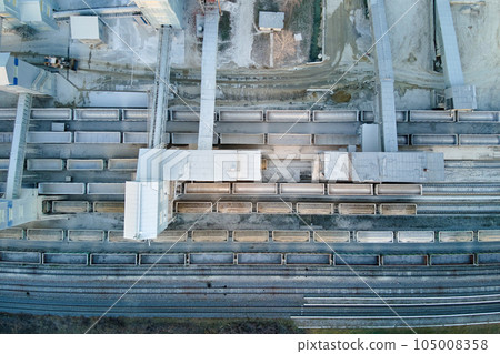 Aerial view of cargo train loaded with crushed stone materials at mining factory. Railway transportation of grinded limestone ore 105008358