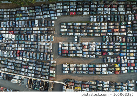 Aerial view of big parking lot of junkyard with rows of discarded broken cars. Recycling of old vehicles 105008385
