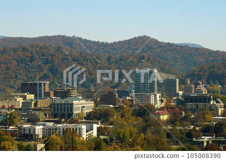 Aerial view of Asheville city in North Carolina with high buildings and mountain hills in distance 105008390