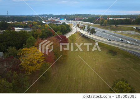 Aerial view of american freeway intersection with fast moving cars and trucks. USA transportation infrastructure concept 105008395