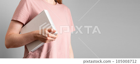 Hand holding abstract closed paper book. Banner background with copy space for text Hand holding abstract closed paper book. Banner background with copy space for text 105008712