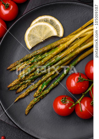 Delicious nutritious breakfast consisting of asparagus, tomatoes, salt, spices and herbs 105009387