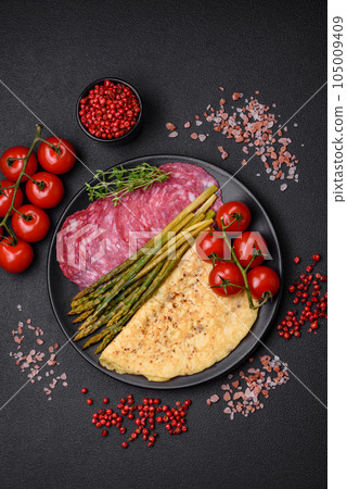 Delicious nutritious breakfast consisting of asparagus, scrambled eggs, salt, spices and herbs Delicious nutritious breakfast consisting of asparagus, scrambled eggs, salt, spices and herbs 105009409