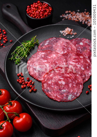 Delicious nutritious breakfast consisting of sliced sausage, asparagus, salt, spices and herbs Delicious nutritious breakfast consisting of sliced sausage, asparagus, salt, spices and herbs 105009431