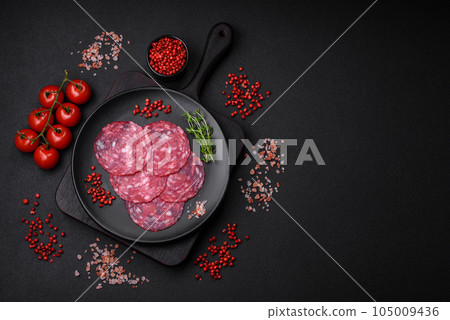 Delicious nutritious breakfast consisting of sliced sausage, asparagus, salt, spices and herbs 105009436