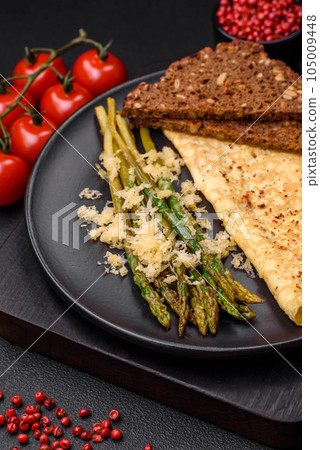 Delicious nutritious breakfast consisting of asparagus, scrambled eggs, salt, spices and herbs Delicious nutritious breakfast consisting of asparagus, scrambled eggs, salt, spices and herbs 105009448