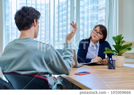 Guy student at therapy meeting with psychologist, mentor in college office 105009666