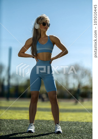 blonde athletic girl stands on the football field 105010445