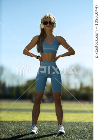 blonde athletic girl stands on the football field 105010447
