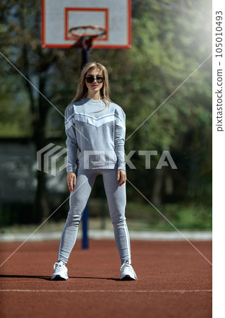 sports girl blonde stands on the basketball court 105010493