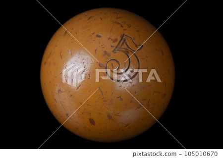 Old vintage billiard ball, number five. On black. 105010670