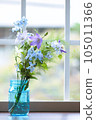 Flowers in a vase by the window 105011366